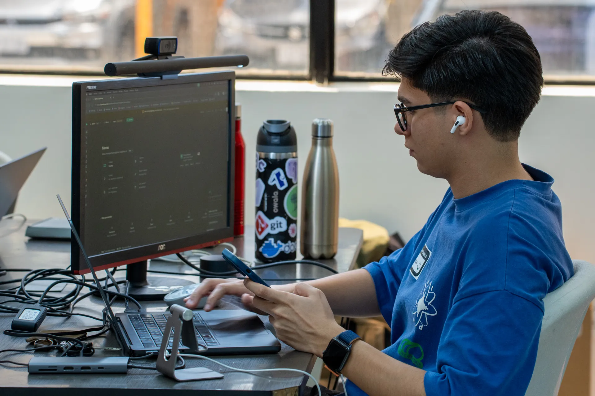 A participant writes code at a monitor during an Ai Labs session.